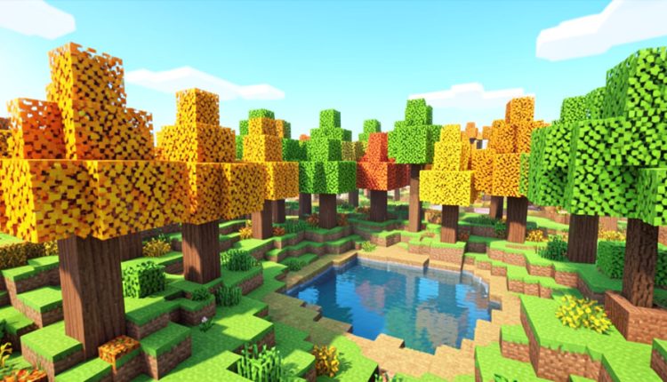 A blocky voxel-style forest with dappled orange and green cube trees around a small pond in a sandbox game landscape
